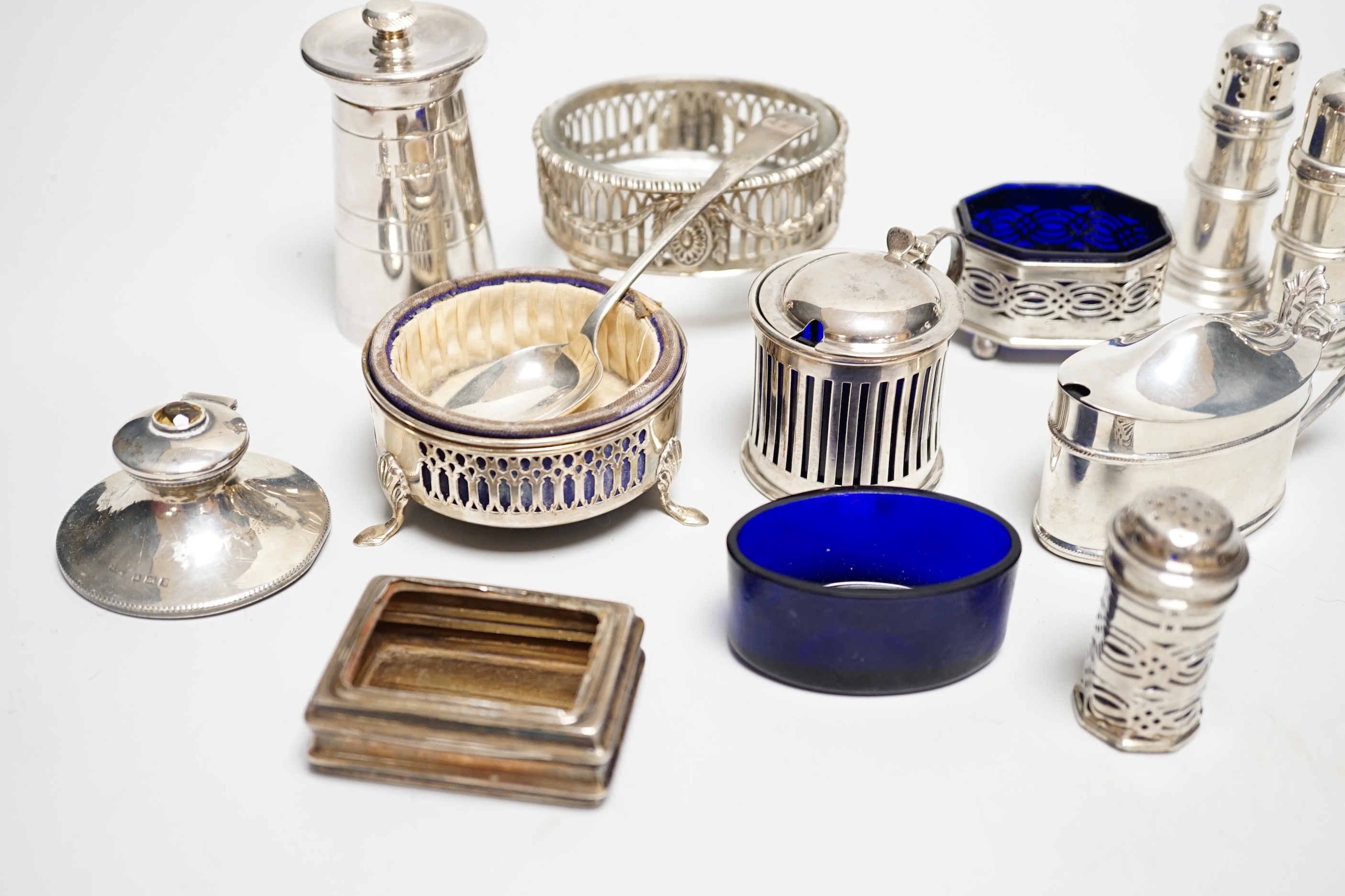 Eight assorted silver condiments, including a George III oval salt and four other items including small inkwell.